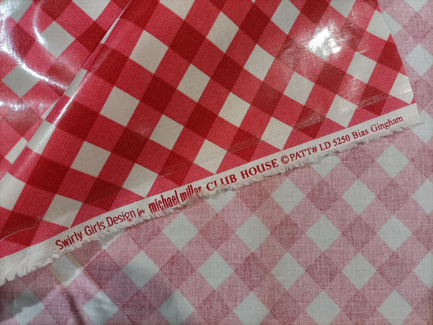 Red and white check laminated cotton with selvedge information